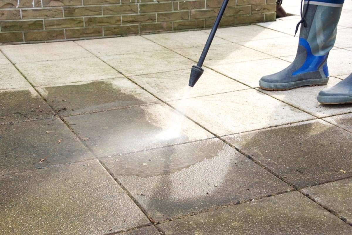 Chris from Brennan's power washing a patio in Yuma, Arizona